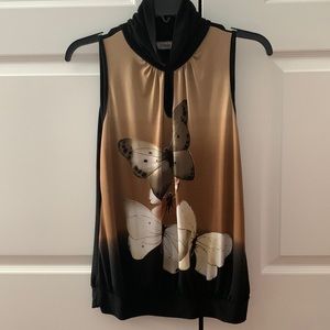 Mock neck novelty print sleeveless top with gathered waist.